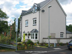 A cream coloured 3 storey house.