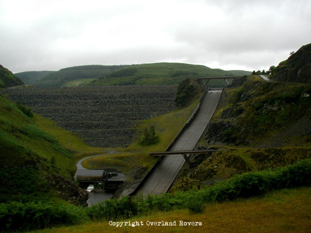 Dam at Llyn Bryne Reservoir with a concrete overflow to one side