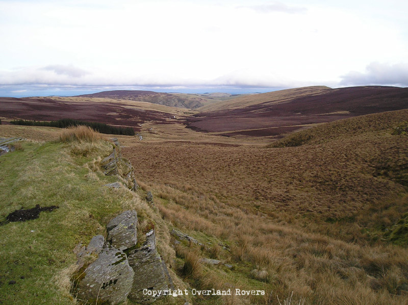 Looking out across an expanse of green and brown hills in Wales