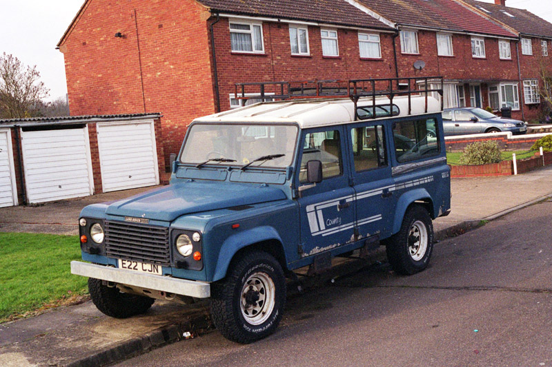 Blue Land Rover 110 V8 County Station Wagon (CSW) parked at side of road